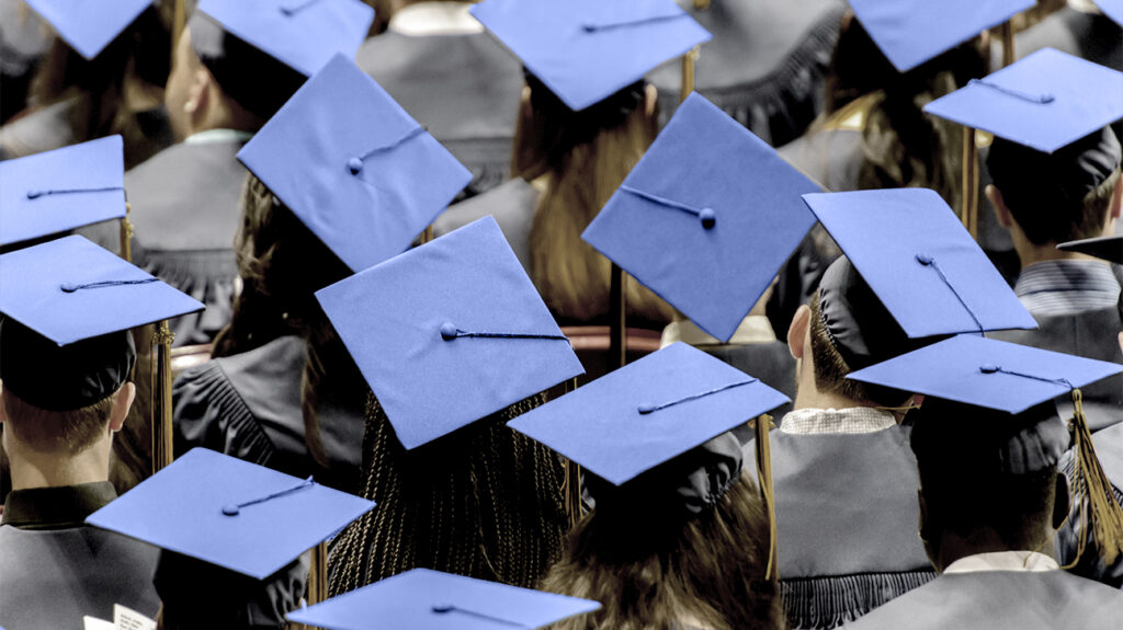 Students wearing caps and gowns at a graduation ceremony